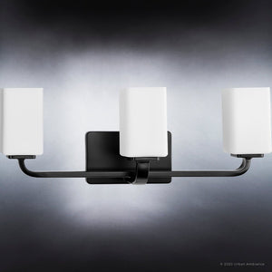 A beautiful lighting fixture from the Louisville Collection by Urban Ambiance, with three white glass shades.