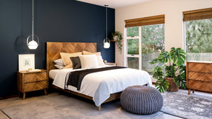A luxury bedroom with dark blue walls and Urban Ambiance wooden furniture.