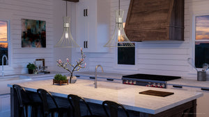 A luxury kitchen with a beautiful island and bar stools featuring the Urban Ambiance UHP4351 Mid-Century Modern Pendant 16''H x 18''W, Burnished Nickel Finish,