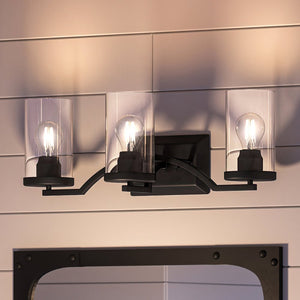 An Urban Ambiance UHP4363 Contemporary Bath Light 8''H x 24''W, Midnight Black Finish, Mesa Collection with three beautiful lights and a mirror.