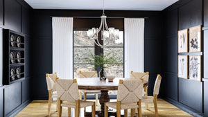 A dining room with black walls and wooden floors adorned with the unique and luxurious Urban Ambiance UHP4368 Contemporary Chandelier 26''H x 26''W, Brushed Nickel Finish,