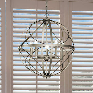A unique lighting fixture, the UHP4405 Farmhouse Chandelier from Urban Ambiance's Omaha Collection, hangs gorgeously over a window with shutters in an Antique Silver Finish.