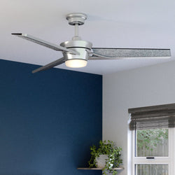A luxury Urban Ambiance UHP9252 Modern Ceiling Fan 15''H x 56''W, Hand-Painted Silver Finish, Melbourne Collection in a bedroom with blue walls.