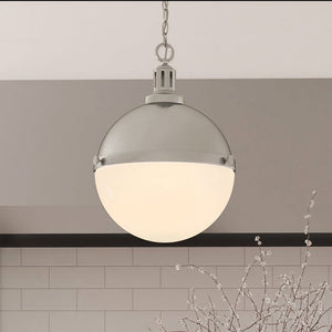 A beautiful lighting fixture, ULB2001 Modern Farmhouse Pendant, hanging over a kitchen counter.