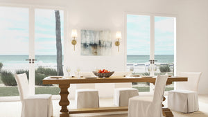 A unique dining room with luxury white chairs, featuring the ULB2071 New-Traditional Wall Sconce in a satin gold finish from Urban Ambiance's Malva Collection.