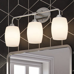 Three unique ULB2113 New-Traditional Bath Lights, 11''H x 23''W, Brushed Nickel Finish, Sandava Collection by Urban Ambiance illuminating a black and white