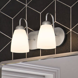 A beautiful bathroom with two unique ULB2123 New-Traditional Bath Lights above a mirror, measuring 7''H x 12''W, with a Brushed Nickel Finish from the Teich