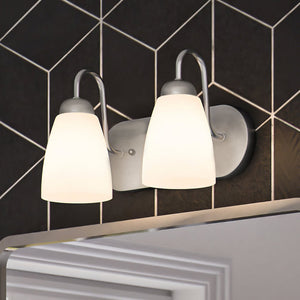 A beautiful bathroom with two unique ULB2123 New-Traditional Bath Lights above a mirror, measuring 7''H x 12''W, with a Brushed Nickel Finish from the Teich