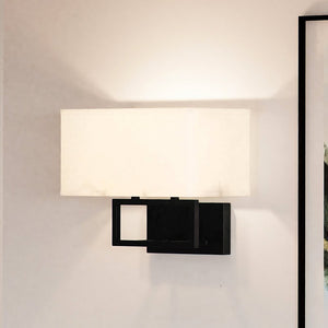 A beautiful ULB2143 New-Traditional Wall Sconce with a black frame and a white shade from the Kells Collection by Urban Ambiance.