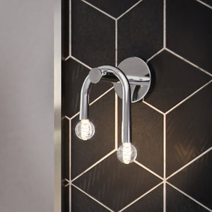 A beautiful bathroom with a ULB2213 Mid-Century Modern Wall Sconce, brushed nickel finish, Kenmare Collection by Urban Ambiance tiled wall.