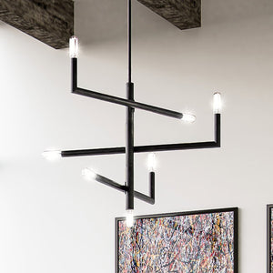 A unique Urban Ambiance ULB2280 Modern Chandelier, 23''H x 27''W, with a Matte Black Finish, hanging above a room with paintings on the wall