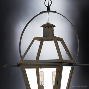 Close-up of the Urban Ambiance UQL1378 Historic Outdoor Pendant Light from the Paris Collection, featuring glass panels and exposed bulbs within a circular metal frame in a Bygone Bronze finish, measuring 23.5″ high by 21.25″ wide, shown suspended against a dark background.