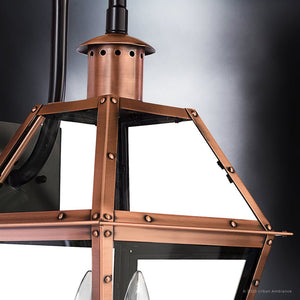 Close-up of the Urban Ambiance UQL1382 Historic Outdoor Wall Light from the Paris Collection, featuring a 22.5″H x 10.5″W handcrafted design in a rustic copper finish with clear glass panels and prominent metal rivets, set against a gradient gray background. This fixture evokes classic vintage outdoor lighting and highlights exquisite craftsmanship.