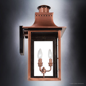 The Urban Ambiance UQL1411 Vintage Outdoor Wall Light from the Longview Collection features a handcrafted rectangular glass enclosure with a rustic copper finish and two candle-style bulbs inside, capturing vintage lantern charm against a plain background.