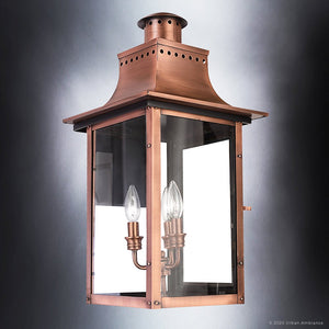 The Urban Ambiance UQL1411 Vintage Outdoor Wall Light from the Longview Collection features a rustic copper finish, clear glass panels, and two candle-style bulbs. Measuring 23 inches high by 12 inches wide, this handcrafted lantern is shown against a neutral gradient background, highlighting its timeless outdoor charm.