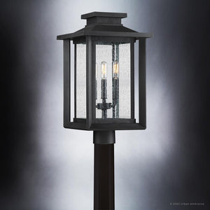 The Urban Ambiance UQL1640 Craftsman Outdoor Post Light from the Peacehaven Collection features marine-grade construction, a natural black finish, and two candle-style bulbs with clear seeded glass panels. Dimensions: 19.25''H x 10.75''W.