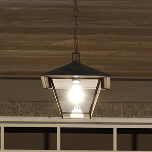 A beautiful Urban Ambiance UQL1651 Coastal Outdoor Pendant 11''H x 10.5''W, Bygone Bronze Finish, Seaford Collection lamp hanging over a door