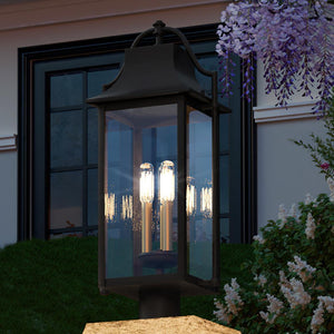 A beautiful stone wall with a UQL1670 Vintage Outdoor Post Light 24.25''H x 10.5''W, Estate Bronze Finish, Eastbourne Collection light fixture on top of