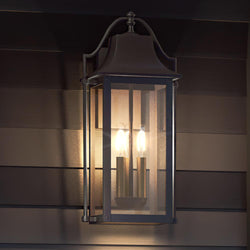 A beautiful vintage lighting fixture, the Urban Ambiance UQL1673 Vintage Outdoor Wall Sconce, adds luxury to the side of a house.