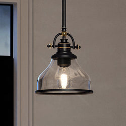A unique UQL3660 Traditional Pendant lamp, hanging over a window, with a beautiful Parisian Bronze finish from Urban Ambiance.