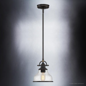 A beautiful lighting fixture with a clear glass shade.