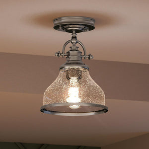 A beautiful Urban Ambiance lighting fixture in a kitchen with a glass shade.