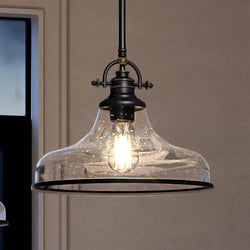 An Urban Ambiance pendant lamp hanging over a table in a room.