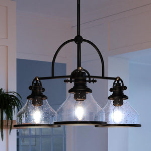 Three beautiful Urban Ambiance UQL3666 Traditional Chandeliers hanging over a kitchen counter.