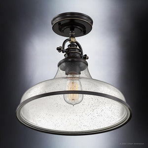 A gorgeous Parisian Bronze finish lighting fixture from the Pasadena Collection with a glass shade.