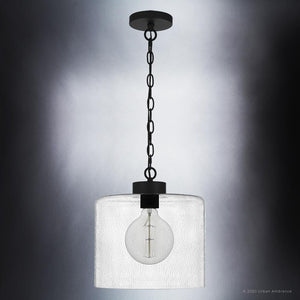 A beautiful pendant light from the Bideford Collection with a glass shade hanging on a chain.