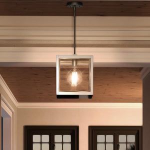 A beautiful and unique Urban Ambiance light fixture hanging from a ceiling in a living room: the UQL3841 Cosmopolitan Pendant 12.75''H x 10''W