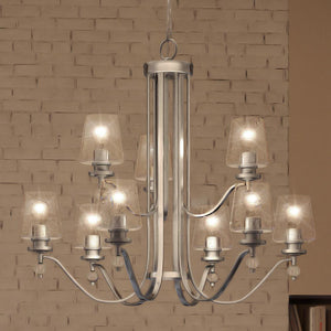 A unique and luxurious UQL3877 Posh Chandelier with six lights in a room with a brick wall, by Urban Ambiance.