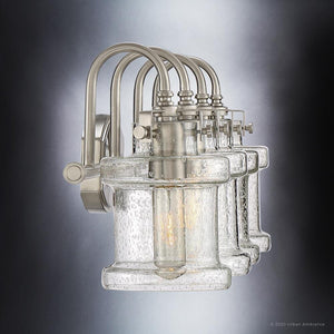 An UQL3984 Modern Farmhouse Bath Fixture 9.75''H x 32''W, Brushed Nickel Finish, Wrexham Collection wall sconce with a beautiful clear glass