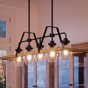 Four beautiful farmhouse chandeliers from the Kendal Collection by Urban Ambiance hanging over a dining room table.