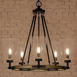 A beautiful Urban Ambiance UQL4061 Farmhouse Chandelier with four glass shades hanging in front of a brick wall.
