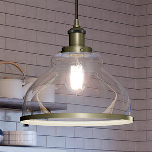 A unique UQL4083 transitional pendant lamp with antique brass finish from the Wyndford Collection by Urban Ambiance, adding luxury to a kitchen counter.