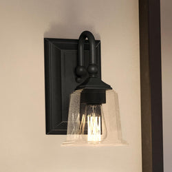 A gorgeous Urban Ambiance UQL4110 Traditional Wall Sconce with a clear glass shade and Natural Black Finish from the Edinburgh Collection.