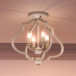 A beautiful Urban Ambiance UQL4131 Art Deco Ceiling 15.5''H x 15''W, Burnished White Finish, Stafford Collection light fixture with three lights on it.