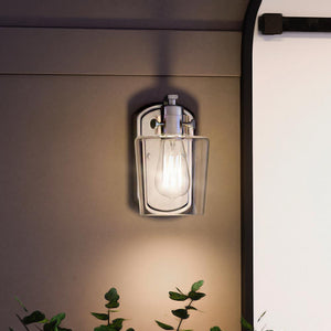 A gorgeous Urban Ambiance UQL4390 Classic Wall Sconce 8''H x 4.75''W with a unique plant next to it.