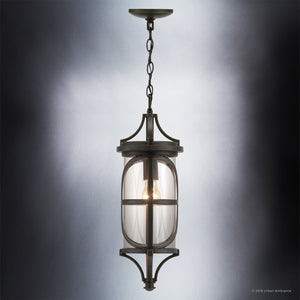 The Urban Ambiance UHP1182 Rustic Outdoor Pendant Light from the Brussels Collection features a die-cast aluminum frame in an Olde Bronze finish and a clear glass shade, suspended by a chain against a gray gradient background; it measures 22″ x 7-1/2″.
