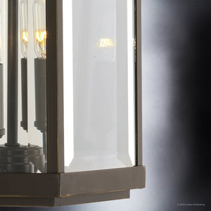 Close-up of the Urban Ambiance UHP1194 Colonial Outdoor Wall Light from the Calderdale Collection, featuring beveled glass and an Olde Bronze finish, with exposed bulbs showcased against a gradient gray background for an elegant, modern look.