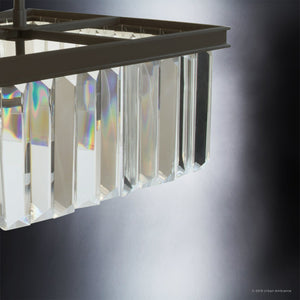 Close-up of Urban Ambiance’s UHP2467 Cosmopolitan Ceiling Light from the Lille Collection, featuring prismatic glass vertical prisms and an Olde Bronze finish, casting subtle rainbow reflections against a dark gray gradient background; dimensions 15-1/2″ x 13-1/8″.