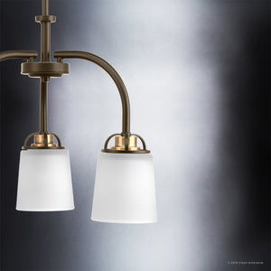 Two pendant light fixtures from the Boise Collection by Urban Ambiance are shown against a gradient gray background, featuring frosted glass shades and metal arms that blend timeless elegance reminiscent of the UHP2764 Transitional Chandelier’s Olde Bronze finish with the clean lines of modern design.