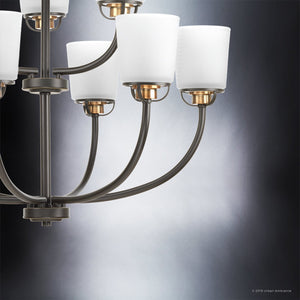 Close-up of the Urban Ambiance UHP2768 Transitional Chandelier from the Boise Collection, measuring 20-3/8″ x 31-1/4″, in an Olde Bronze finish. The fixture showcases elegantly curved dark metal arms and white cylindrical lampshades, set against a gradient gray background.