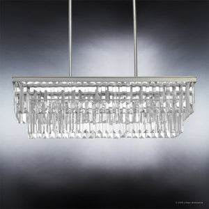 The Urban Ambiance UHP2883 Cosmopolitan Chandelier from the Lille Collection, measuring 11″ x 33-7/8″ with an Antique Silver finish, features multiple hanging prisms of prismatic glass and two metal rods, elegantly suspended against a gradient gray background.