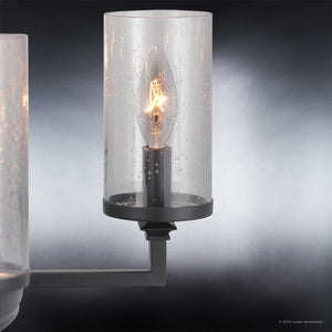 A close-up of the Urban Ambiance UHP2892 XL Rustic Chandelier from the Livorno Collection, featuring a candle-shaped bulb inside seeded glass with small bubbles, mounted on a charcoal-finished fixture.