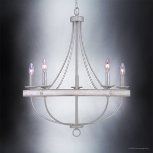 The Urban Ambiance UHP2900 Farmhouse Chandelier from the Adelaide Collection features a 30″ x 26″ round wooden frame, elegantly curved metal arms in a galvanized steel finish, and five candle-style bulbs. Suspended by a chain against a gradient background, this vintage-inspired fixture adds rustic charm and classic farmhouse lighting to any space.