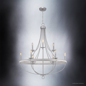 The Urban Ambiance UHP2902 XL Farmhouse Chandelier from the Adelaide Collection showcases a galvanized steel finish and measures 40-1/2″ by 35″. Its modern open cage design features eight candle-style bulbs arranged in a circular metal frame, suspended by a chain against a gradient gray background.
