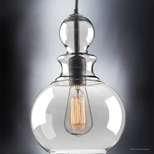 Suspended by a cord against a neutral background, the Urban Ambiance UHP3047 Modern Farmhouse Pendant Light from the Dundee Collection features a clear glass shade and visible filament bulb. Its 12-3/4″ x 8-1/2″ silhouette and charcoal finish make it an elegant example of vintage-inspired modern lighting that blends timeless farmhouse charm with contemporary style.
